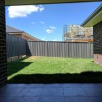 Raked colorbond fence